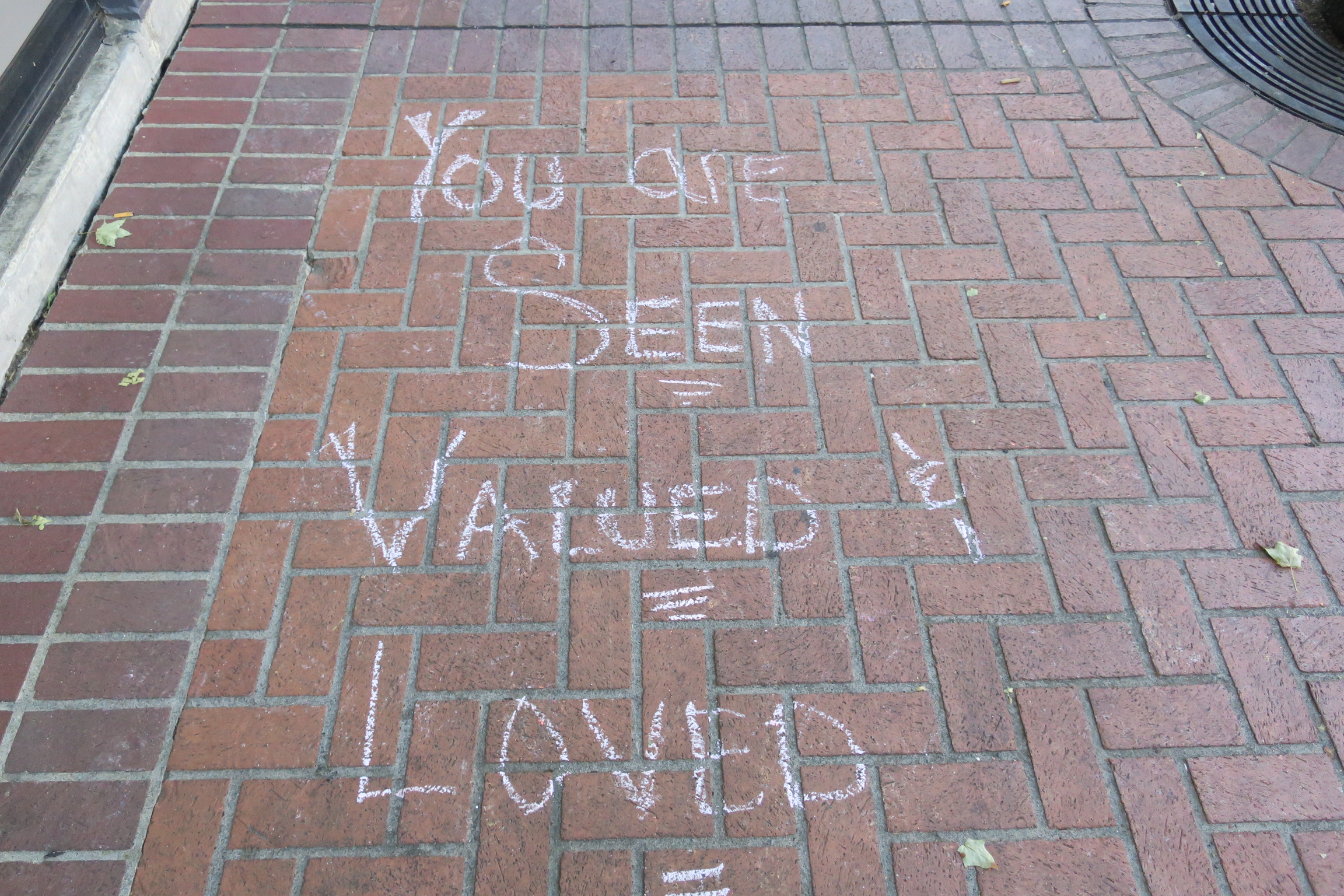 chalk writing on sidewalk with inspirational message