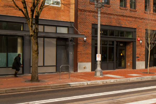 Brick city building with a tree and streetlight outside