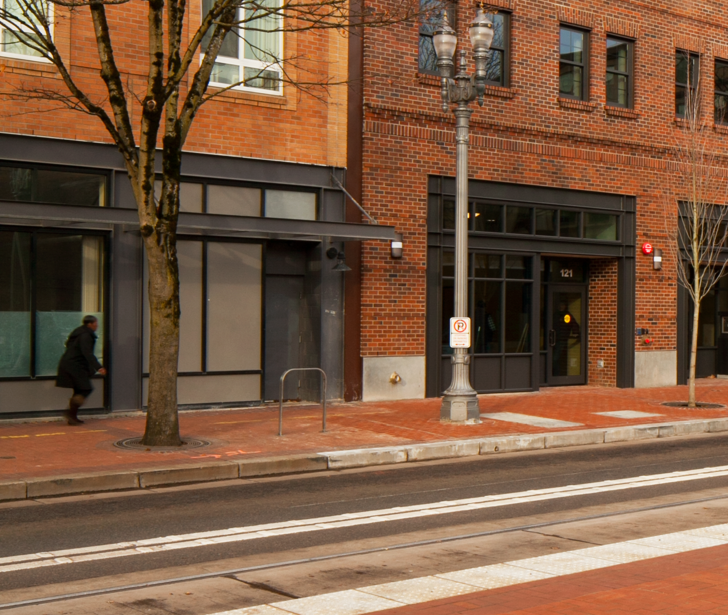 Brick city building with a tree and streetlight outside