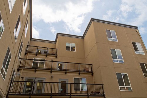 Tan stucco building with balconies